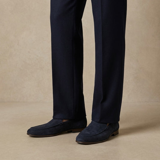 Donald Pliner Slater loafer in black leather, featuring classic slip-on design and sleek stitching details.