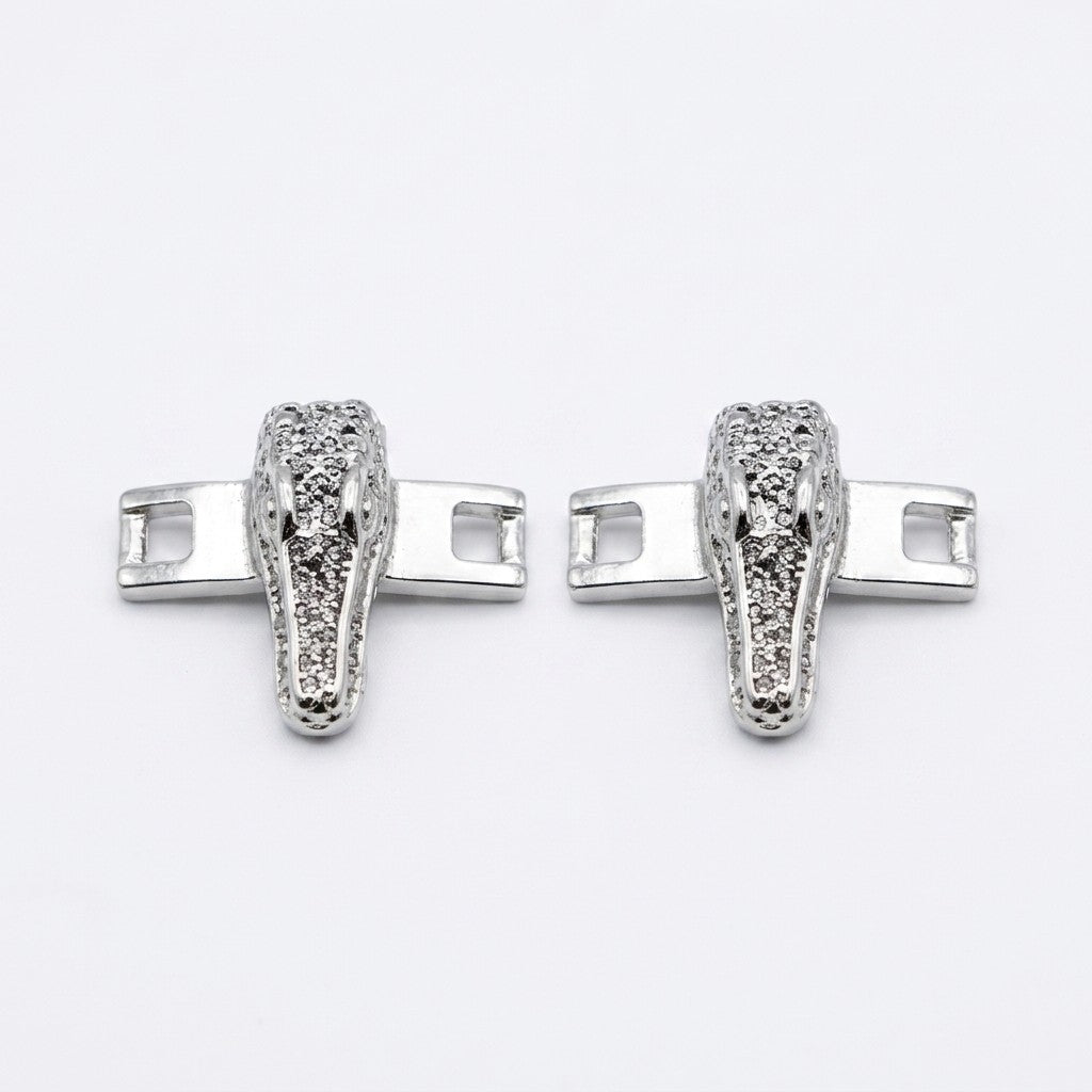 Mauri alligator shoe lace bar accessories in gold and silver with intricate design, suitable for footwear embellishment.