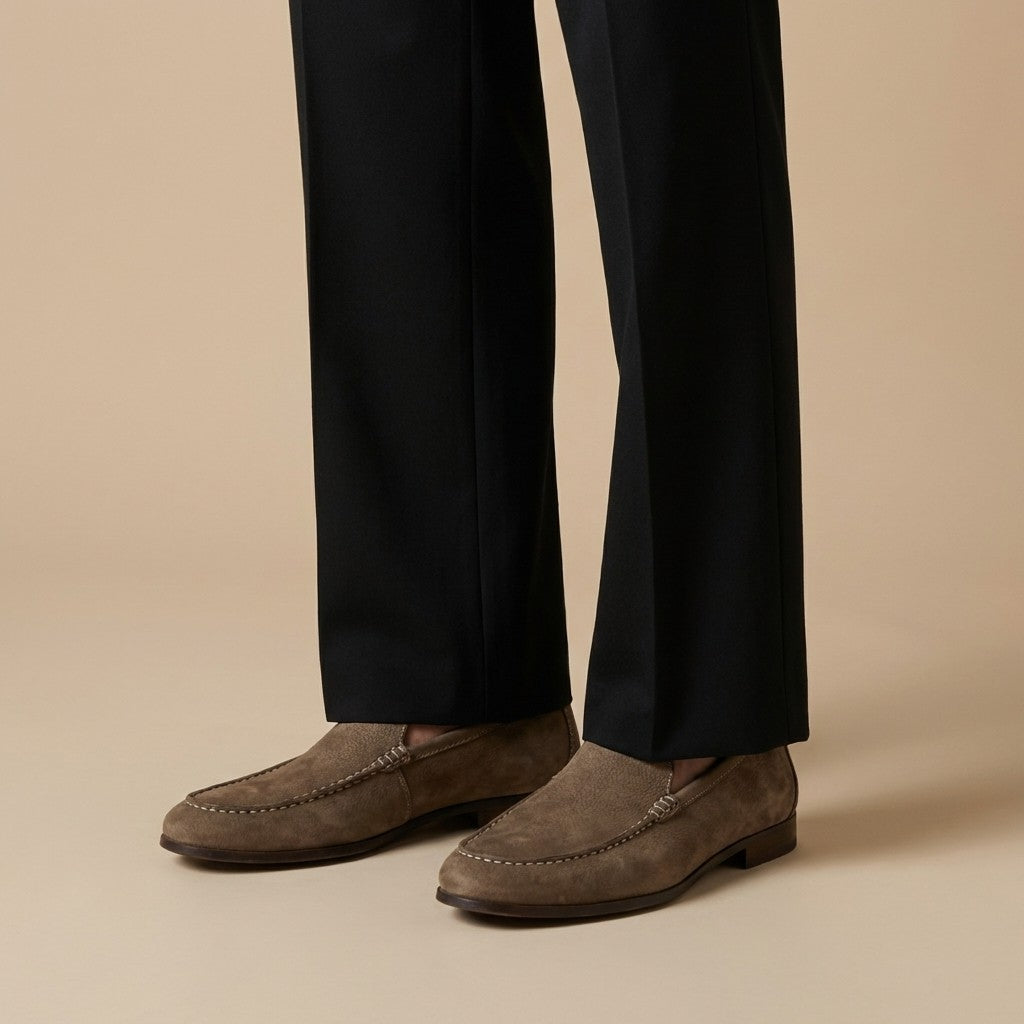 Donald Pliner Slater loafer in black leather, featuring a sleek design and slip-on style, close-up view of the stylish footwear.