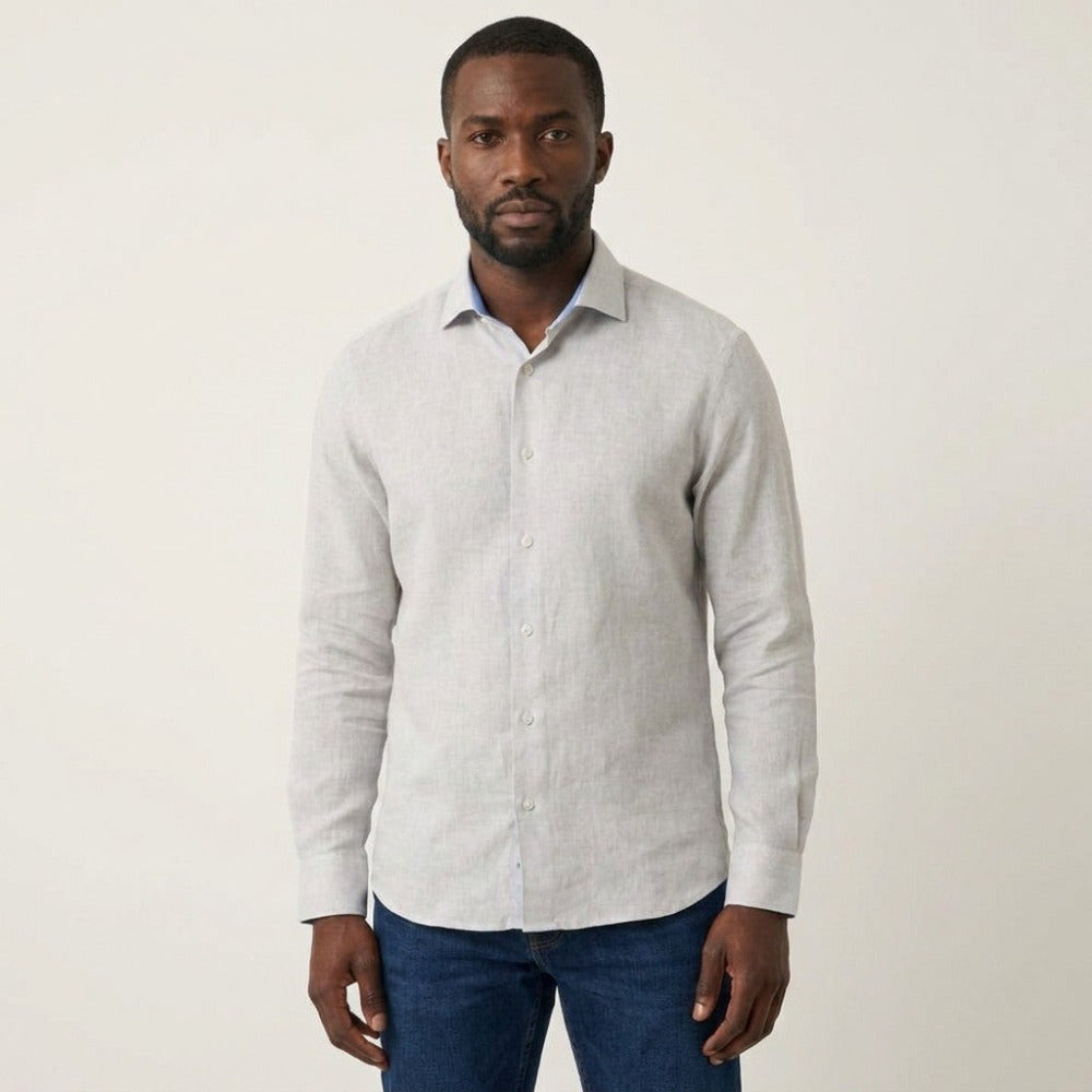 White Torras premium 100% Italian linen long-sleeve shirt displayed on a hanger, showcasing its lightweight, breathable fabric and classic style.