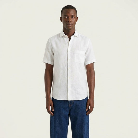 White Torras premium Italian 100% linen short-sleeve shirt displayed on a hanger, showcasing its lightweight, breathable fabric and classic design.