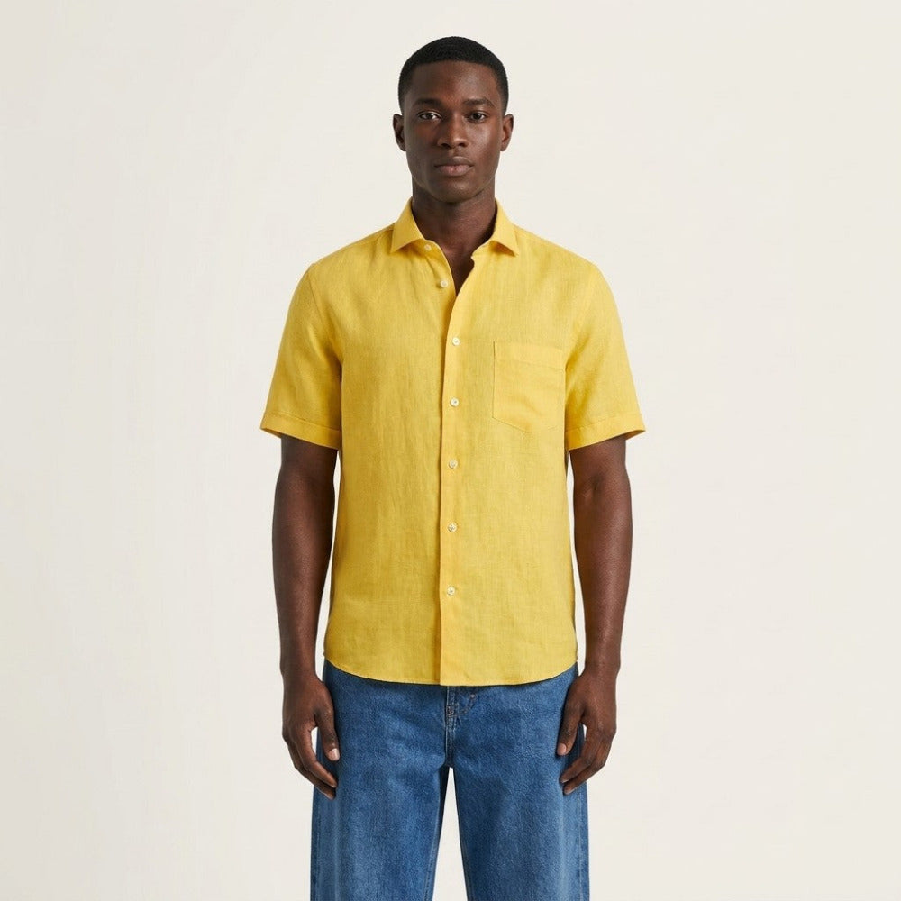 Torras premium Italian 100% linen short-sleeve yellow shirt displayed on a hanger, lightweight and breathable summer shirt.
