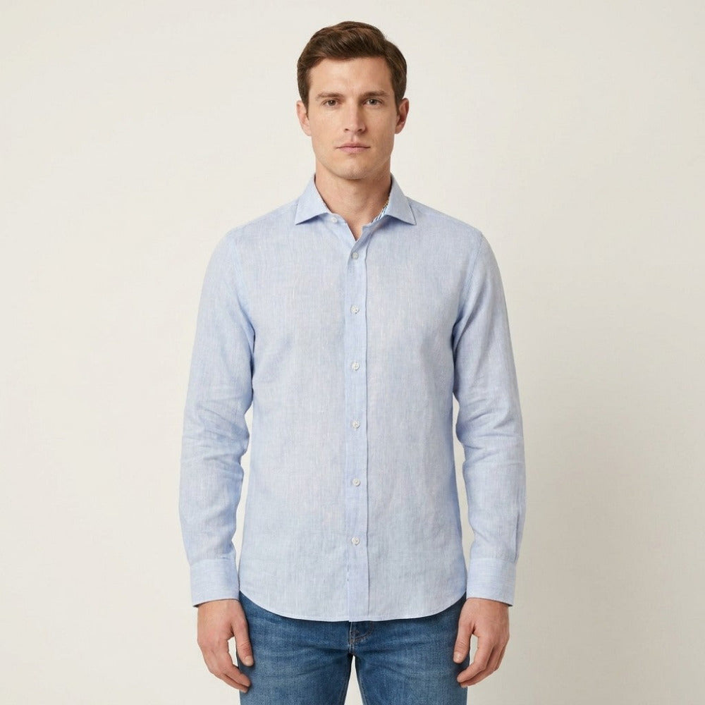 Blue Andrea Bossi linen button-up long-sleeve shirt displayed on a hanger, showcasing a casual, lightweight top for women.