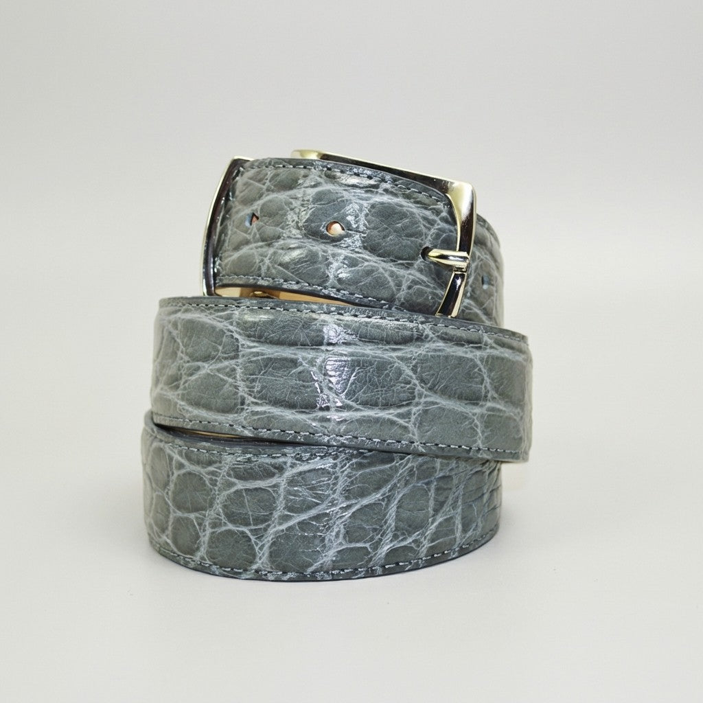 Grey Mauri alligator belt with textured pattern and sleek buckle, showcasing luxurious leather craftsmanship.