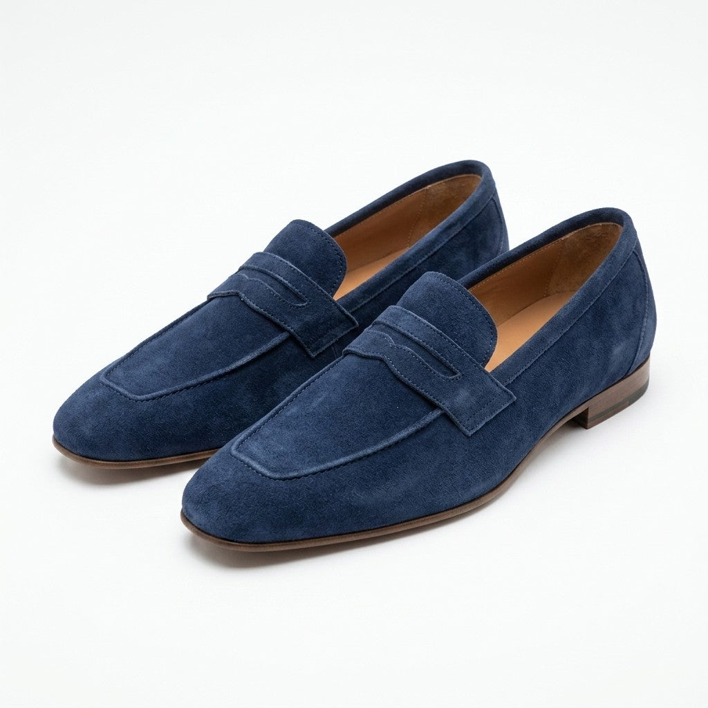 Donald Pliner Jayce navy blue suede penny loafers with classic slip-on design and sleek stitching details.