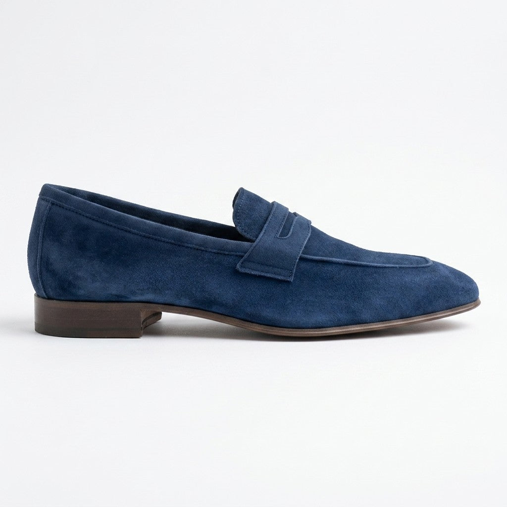 Donald Pliner Jayce navy blue suede penny loafers displayed on a neutral background, showcasing their classic loafer style and rich suede texture.
