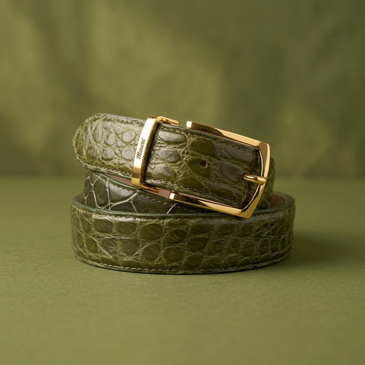 Olive green Mauri alligator leather belt with a sleek buckle, showcasing luxurious texture and craftsmanship.
